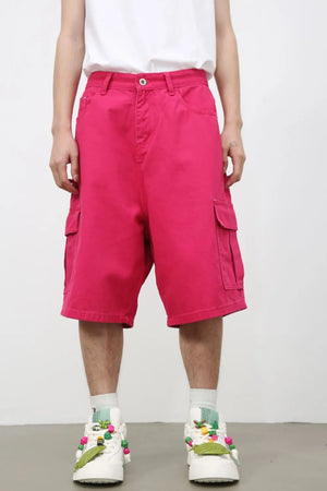Magenta baggy cargo Bermuda shorts with multiple pockets and a buttoned waist.