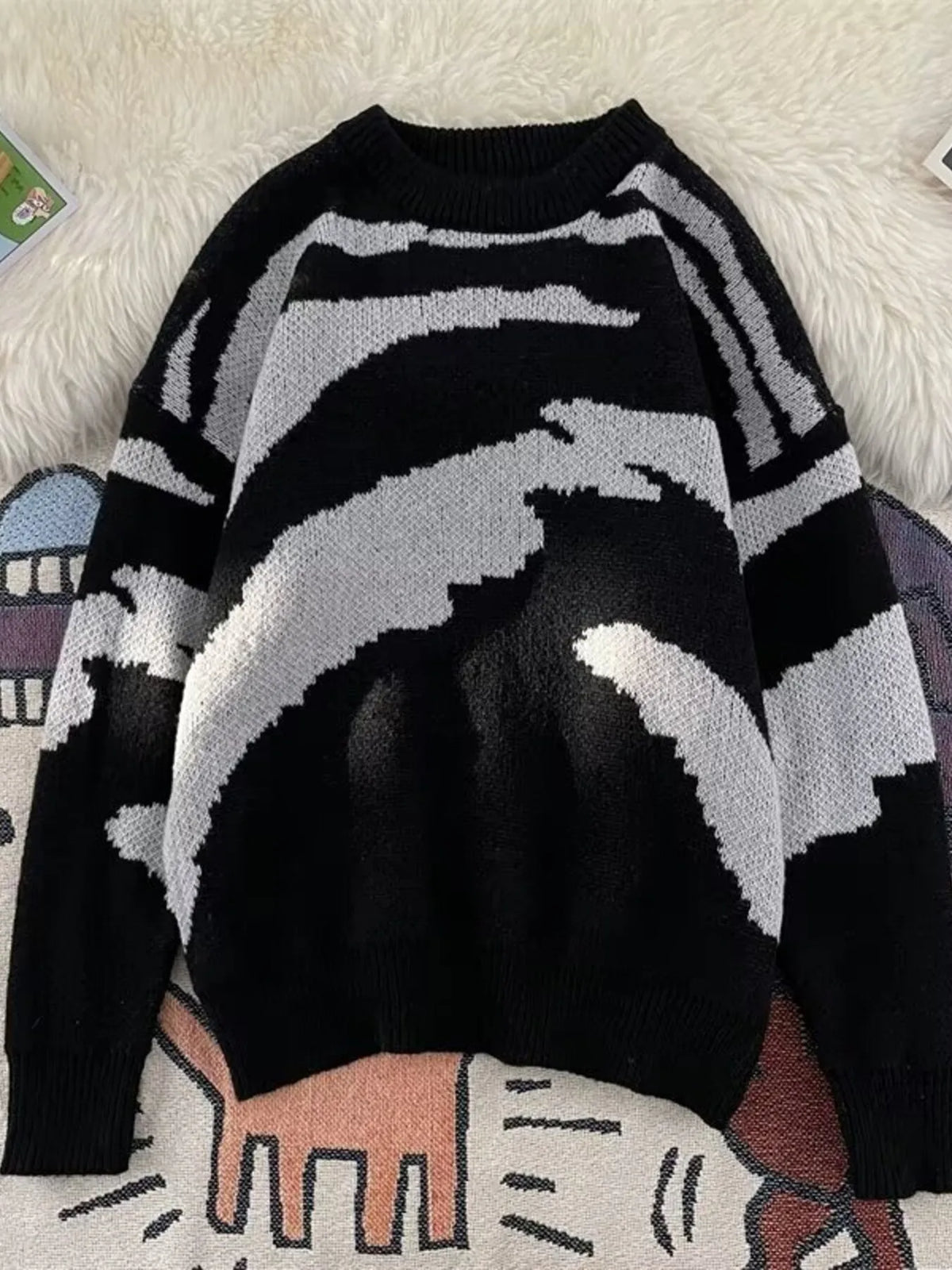Men's black and white abstract print round-neck sweater with long sleeves.