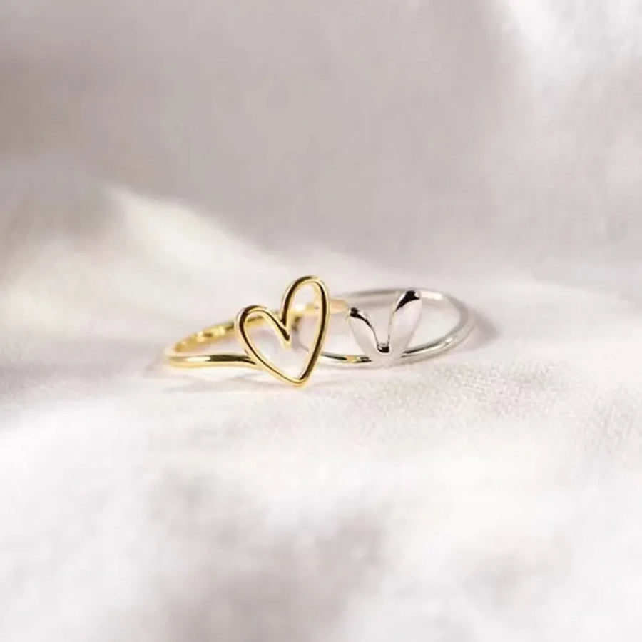 Gold two-tone heart outline ring with a delicate band.