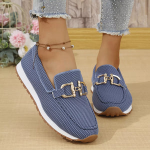 Blue mesh slip-on loafers with gold buckle detail and white soles.