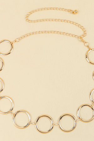 Gold geometric circle waist chain with a delicate link chain and clasp closure.