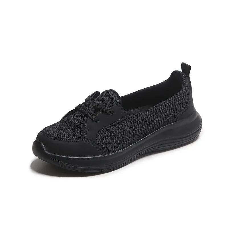 Black mesh and leather slip-on flats with a platform sole.