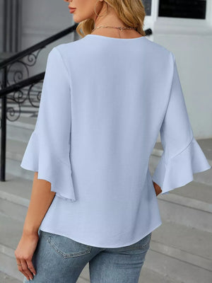 Sky blue V-neck blouse with ruffle sleeves and a textured fabric.