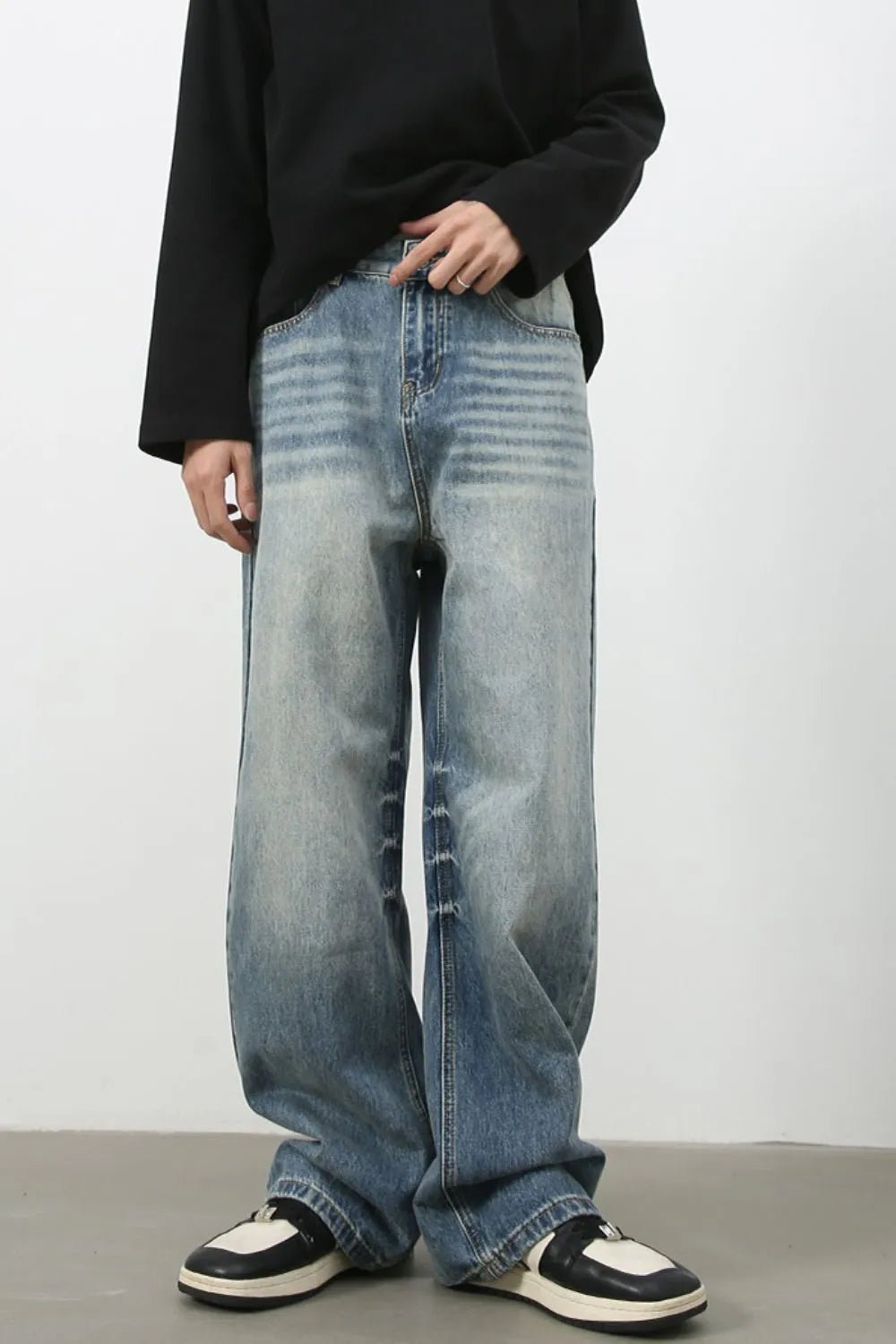Baggy wash denim trousers in medium blue with a faded effect and horizontal stripe detailing.