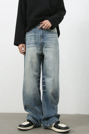 Baggy wash denim trousers in medium blue with a faded effect and horizontal stripe detailing.