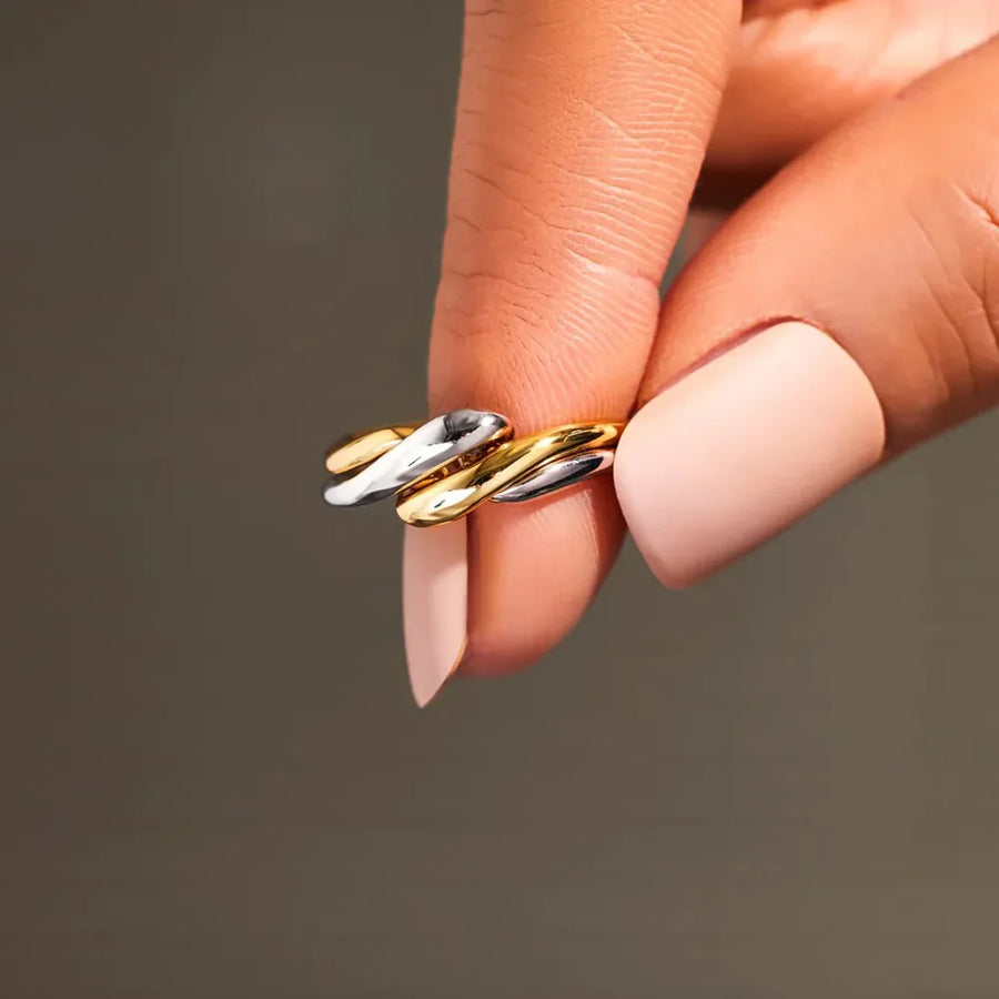 Two-tone gold and silver intertwined open ring with a smooth, polished finish.