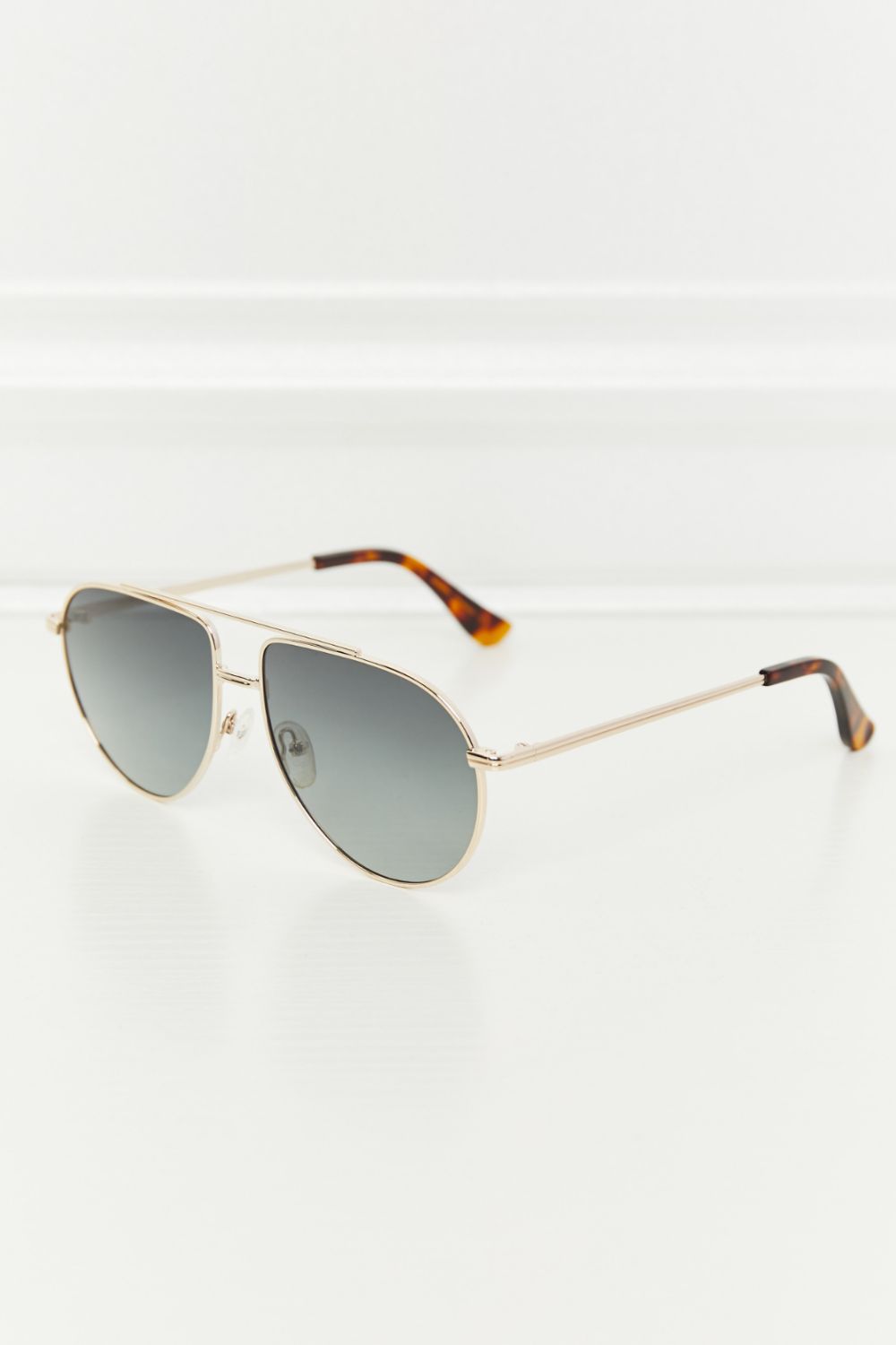 Gradient lens aviator sunglasses with gold frames and tortoise shell temple tips.