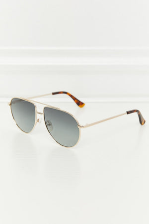 Gradient lens aviator sunglasses with gold frames and tortoise shell temple tips.