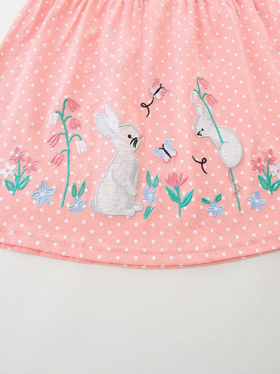Pink polka dot dress with embroidered bunnies, butterflies and flowers.