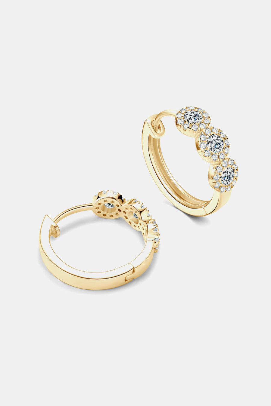 Gold triple cluster diamond huggie hoop earrings with sparkling stones.