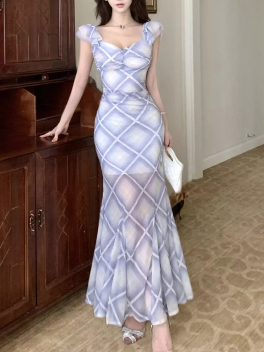 Blue ruched plaid bodycon maxi dress with sweetheart neckline and ruffled cap sleeves.