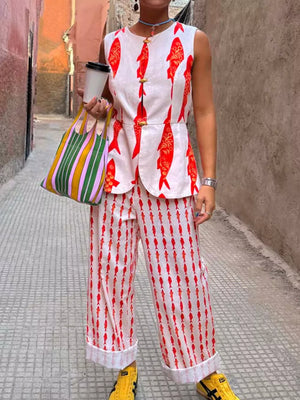 Red fish print two-piece set with button detail on sleeveless top and wide-leg pants.