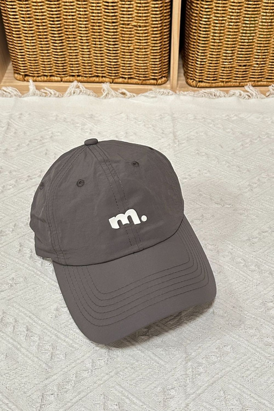 Grey baseball cap with white "m." logo