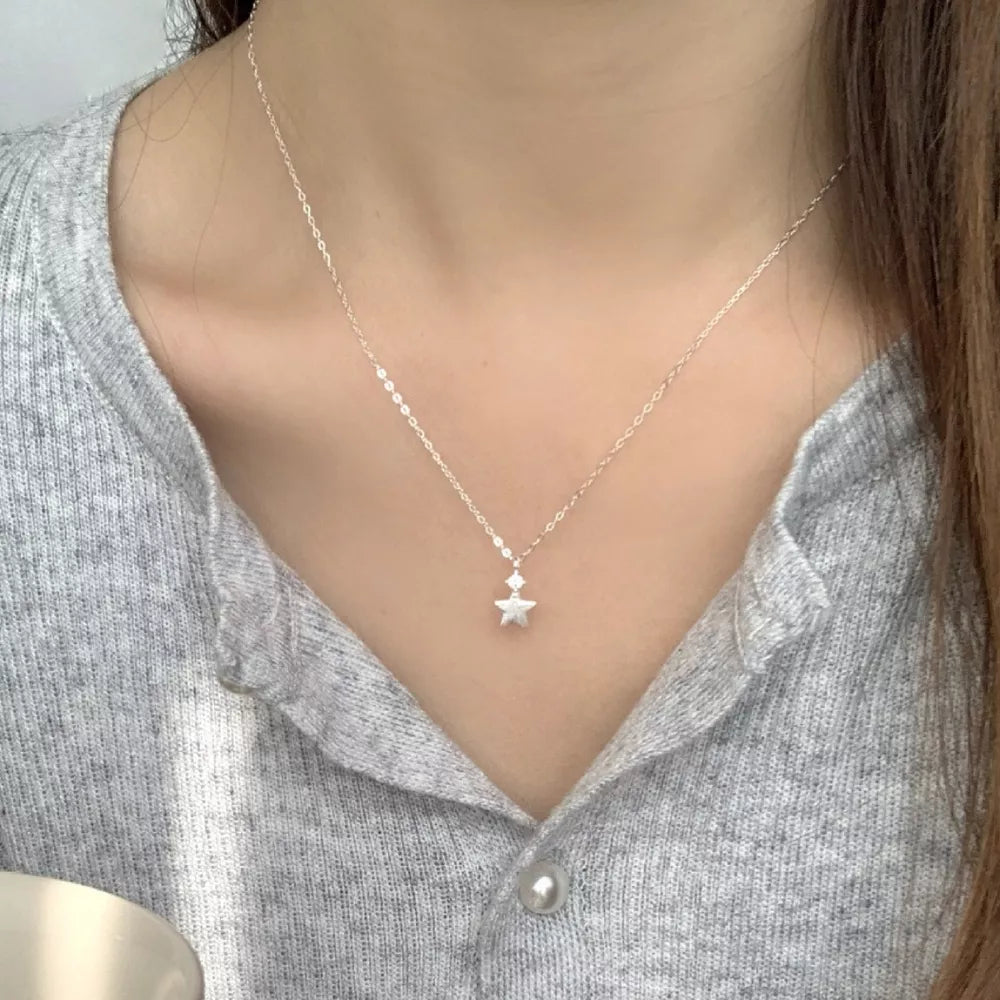 necklace in silver with geometric and star pendant