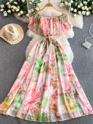 Botanical off-shoulder A-line dress in light pink with floral print, belted waist, and flowing skirt.