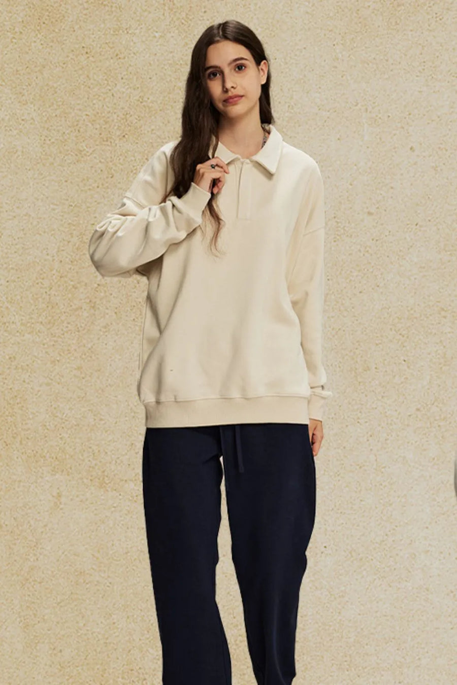 Oversized cream polo sweatshirt with collar and long sleeves, worn by a model.