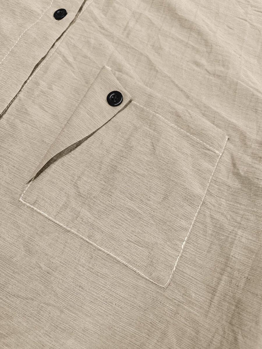 100% polyester Care instructions: Machine wash cold button-down shirt in khaki with relaxed silhouette