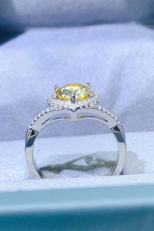 Yellow moissanite halo engagement ring in silver with a twisted band.