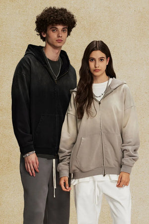 Oversized zip-up hoodie in black and gray with vintage wash effect and front pockets.