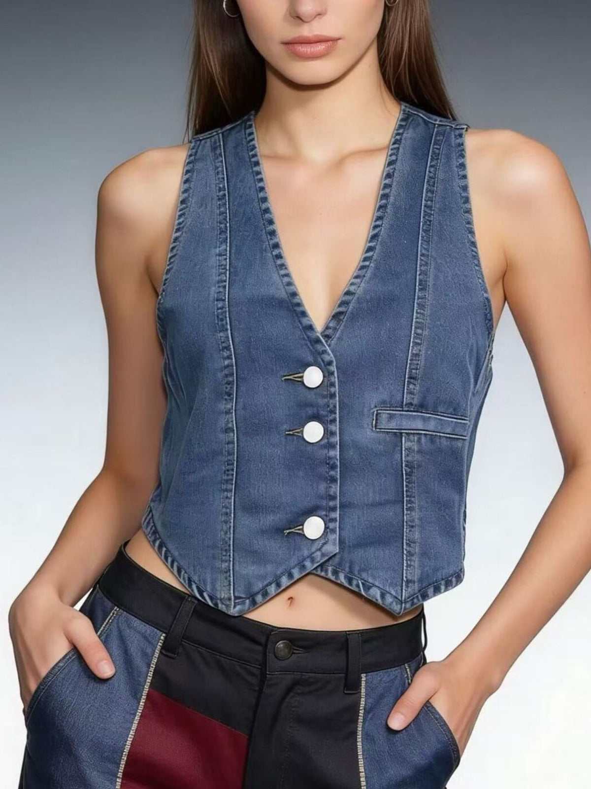 Chic button-down denim vest in dark blue with white buttons and a V-neck.