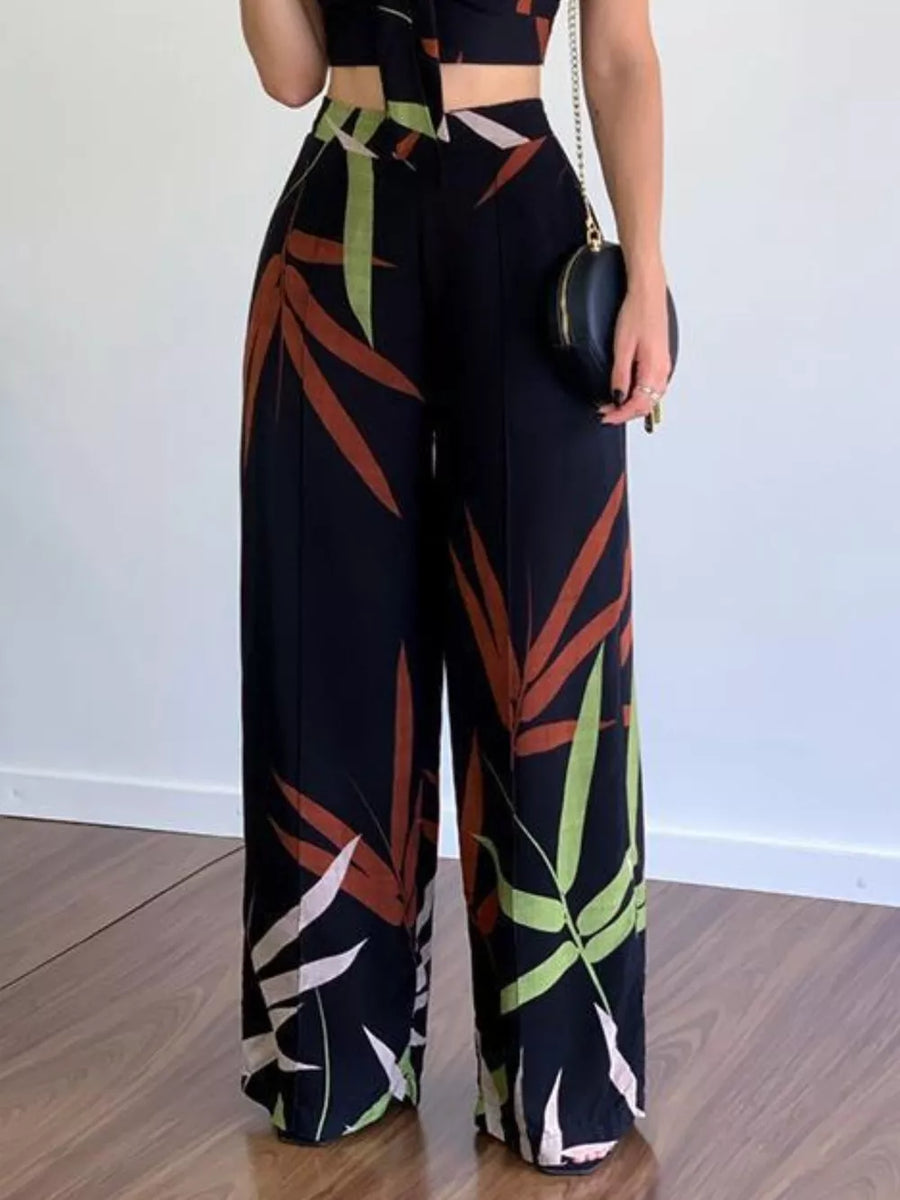 Black tropical print crop top and wide-leg pants set with V-neck and polyester fabric.