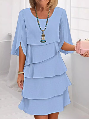 Light blue ruffled layered flutter sleeve dress with tiered skirt.