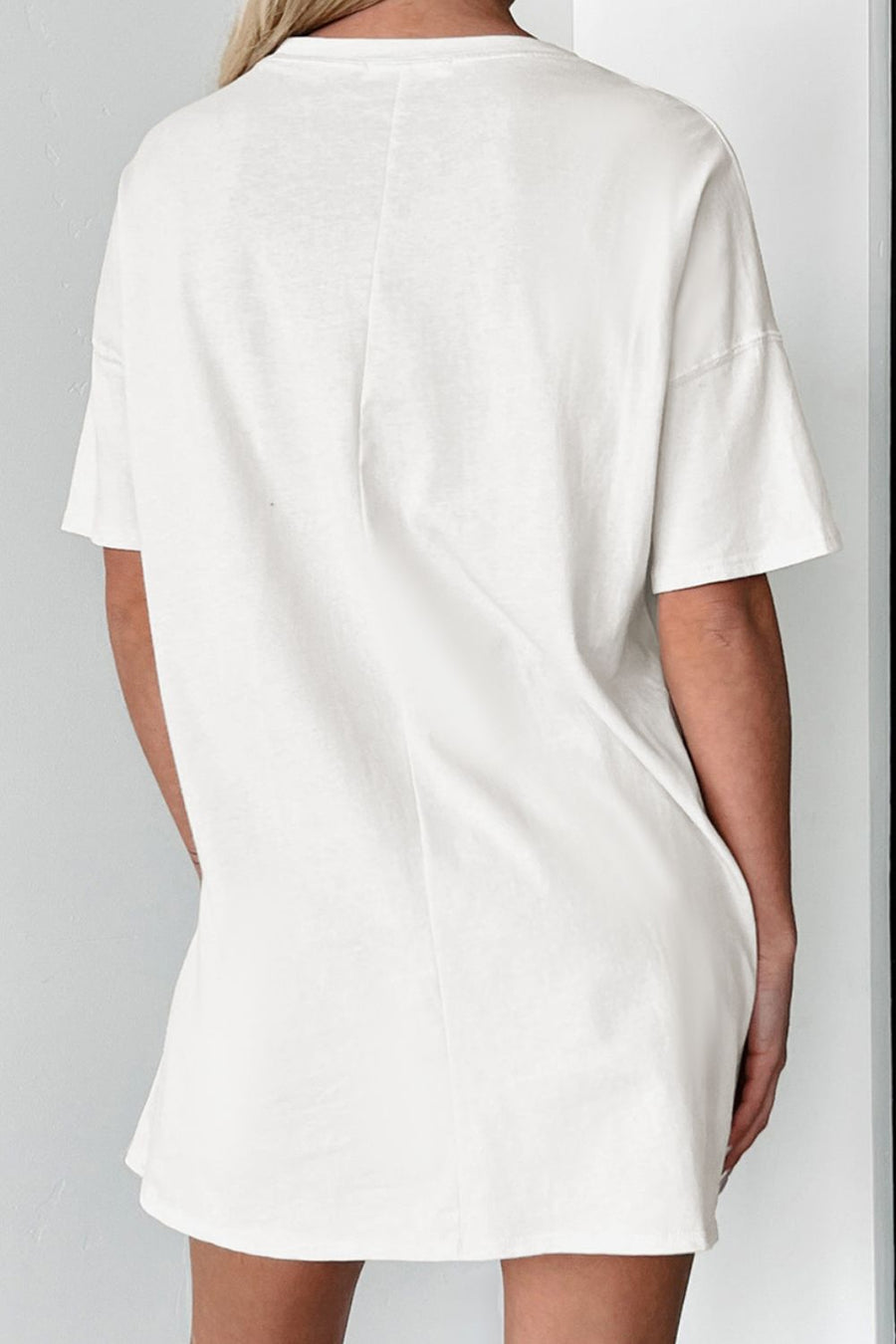 White cotton blend tee dress with short sleeves and a relaxed fit.