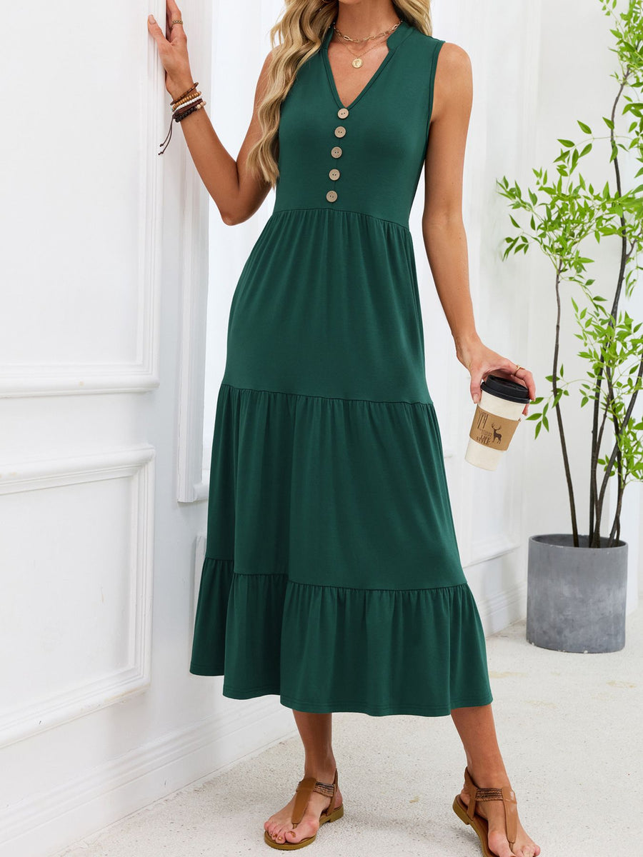 Dark green tiered midi dress with notched V-neck and decorative buttons.