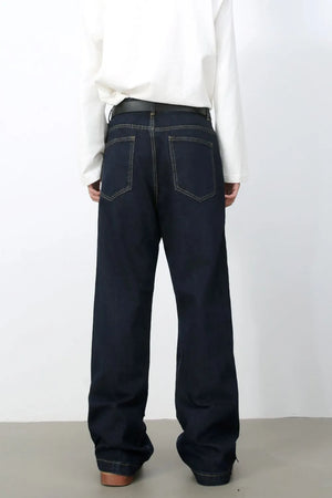 Dark wash denim carpenter jeans with a wide, relaxed fit and contrast stitching.