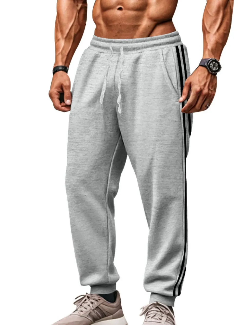 Gray joggers with black athletic stripes on the side, drawstring waist, and cuffed ankles.