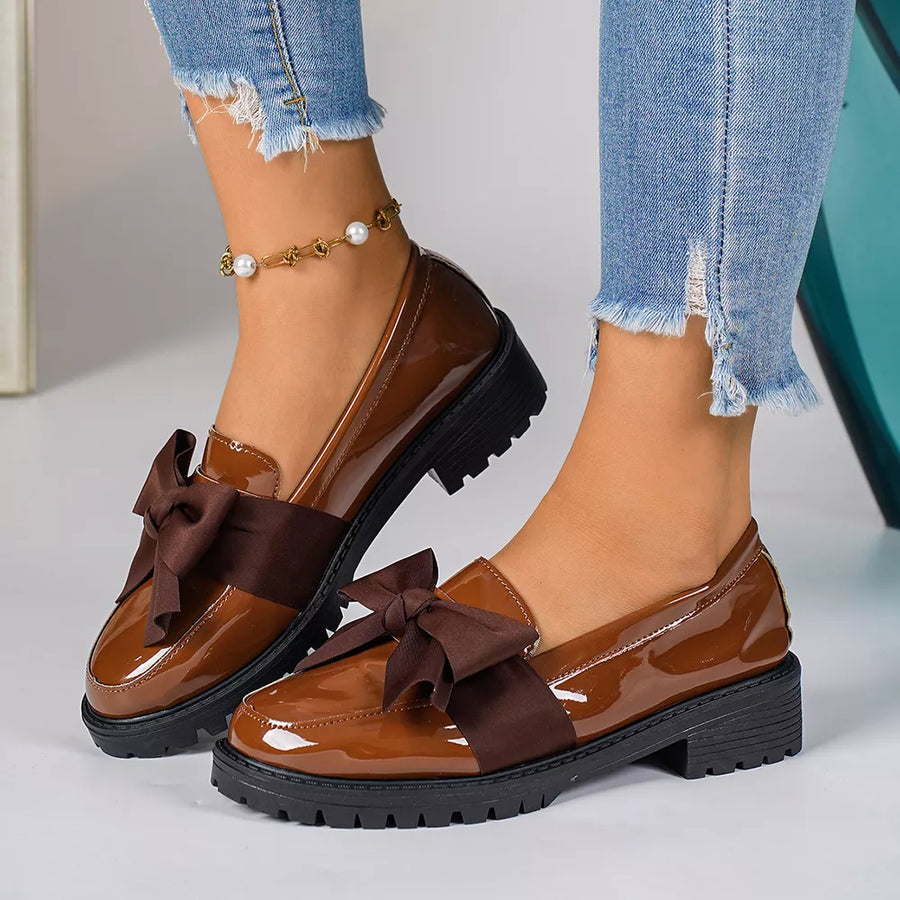 Brown patent loafers with bow detail and lug sole