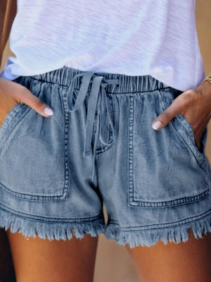 denim shorts in Light Blue with raw hem and mini