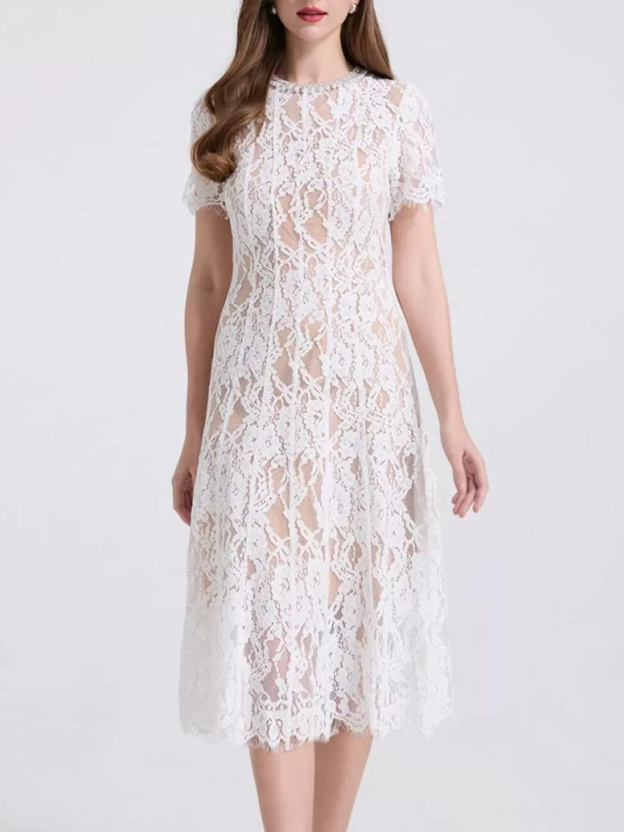 White lace midi dress with pearl embellishments and short sleeves.