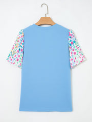 Textured blue blouse with abstract floral bubble sleeves