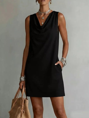 Black sleeveless cowl neck mini dress with pockets and a relaxed fit.