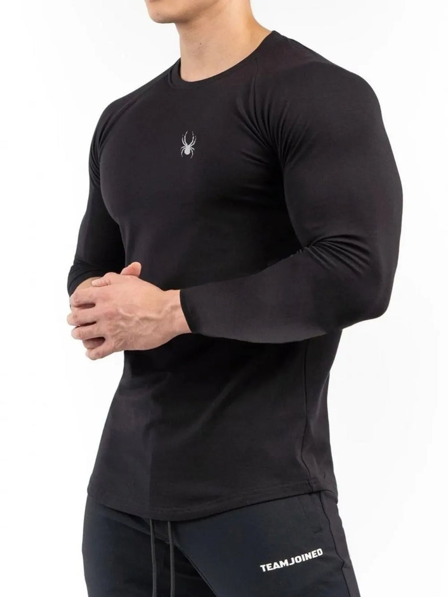 Black performance long sleeve top with spider logo on chest
