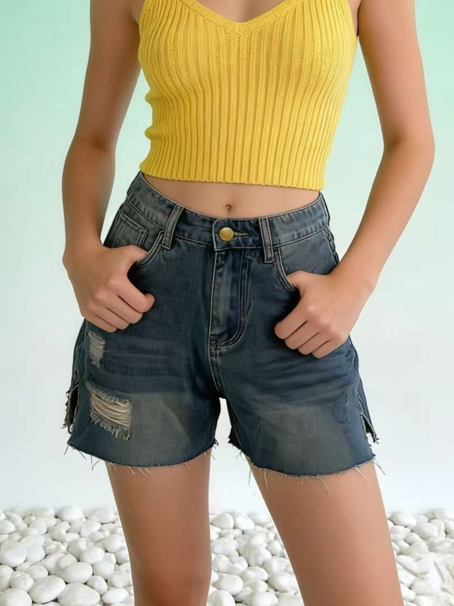 Frayed hem denim shorts with distressed details and a button closure.