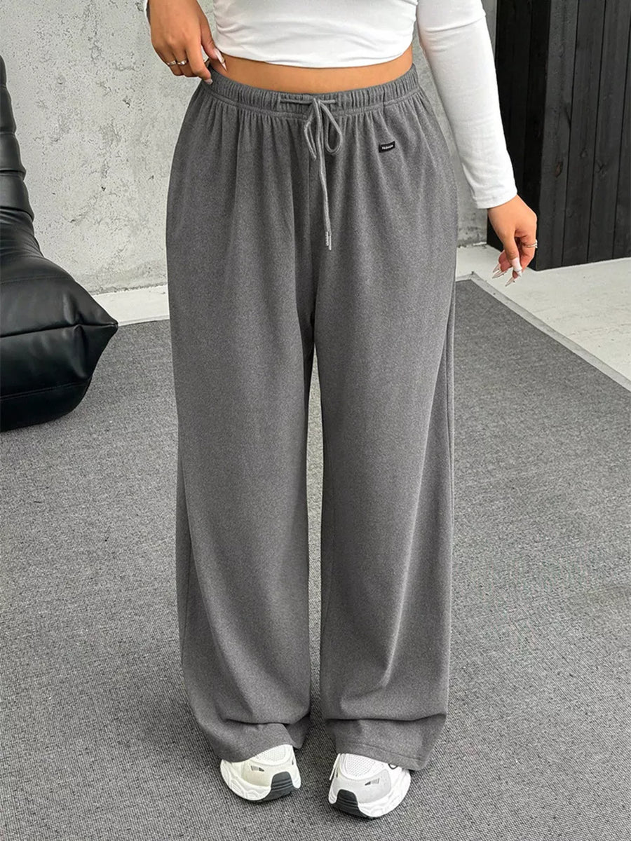Maternity wide-leg pants in gray with drawstring waist and pockets.