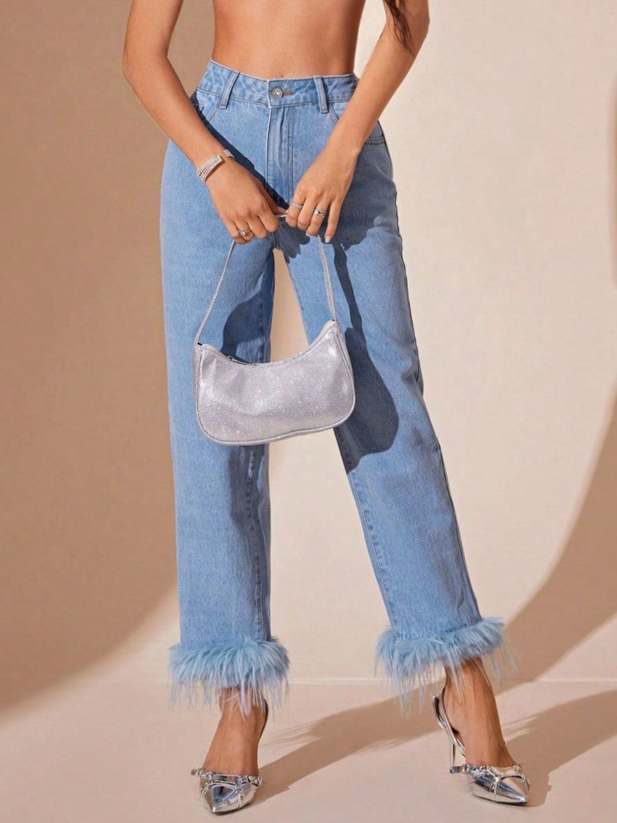 Light wash denim jeans with feather trim at the hem and a high rise.