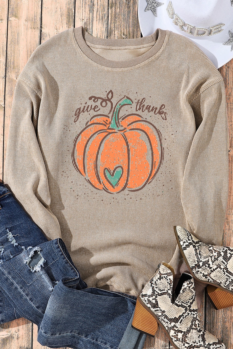 Ribbed tan sweatshirt with pumpkin graphic and "give thanks" text.
