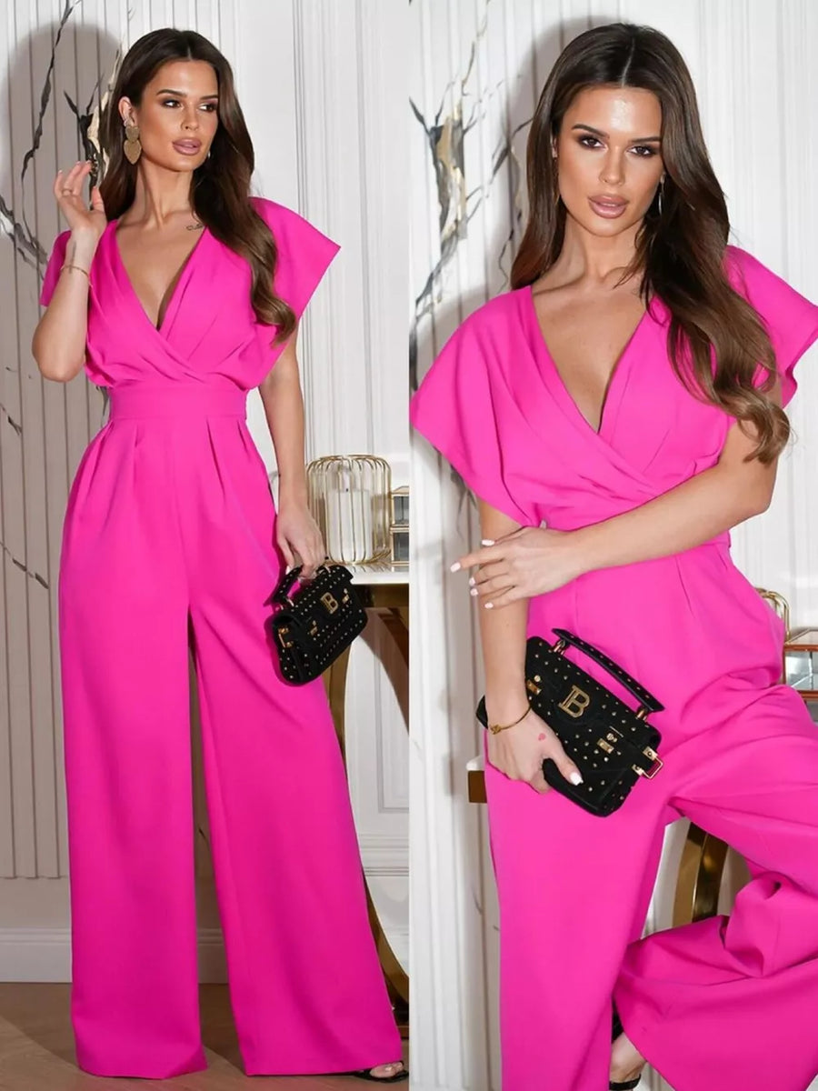 Hot pink wide-leg romper with surplice neckline and short flutter sleeves.