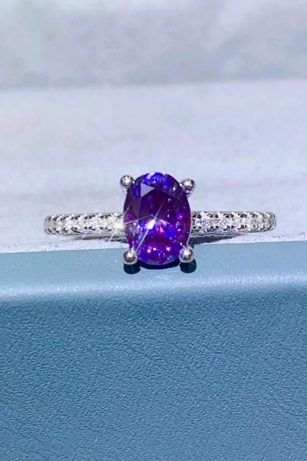 Amethyst oval pavé ring with a silver band.