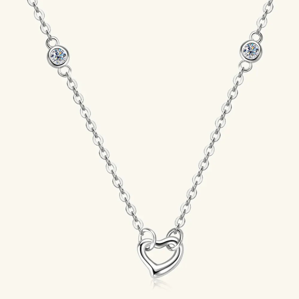 Silver linked heart pendant necklace with bezel-set crystal accents.