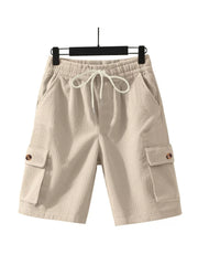 Apricot textured drawstring cargo shorts with button flap pockets.