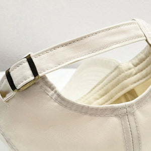 Cream baseball cap with adjustable strap detail