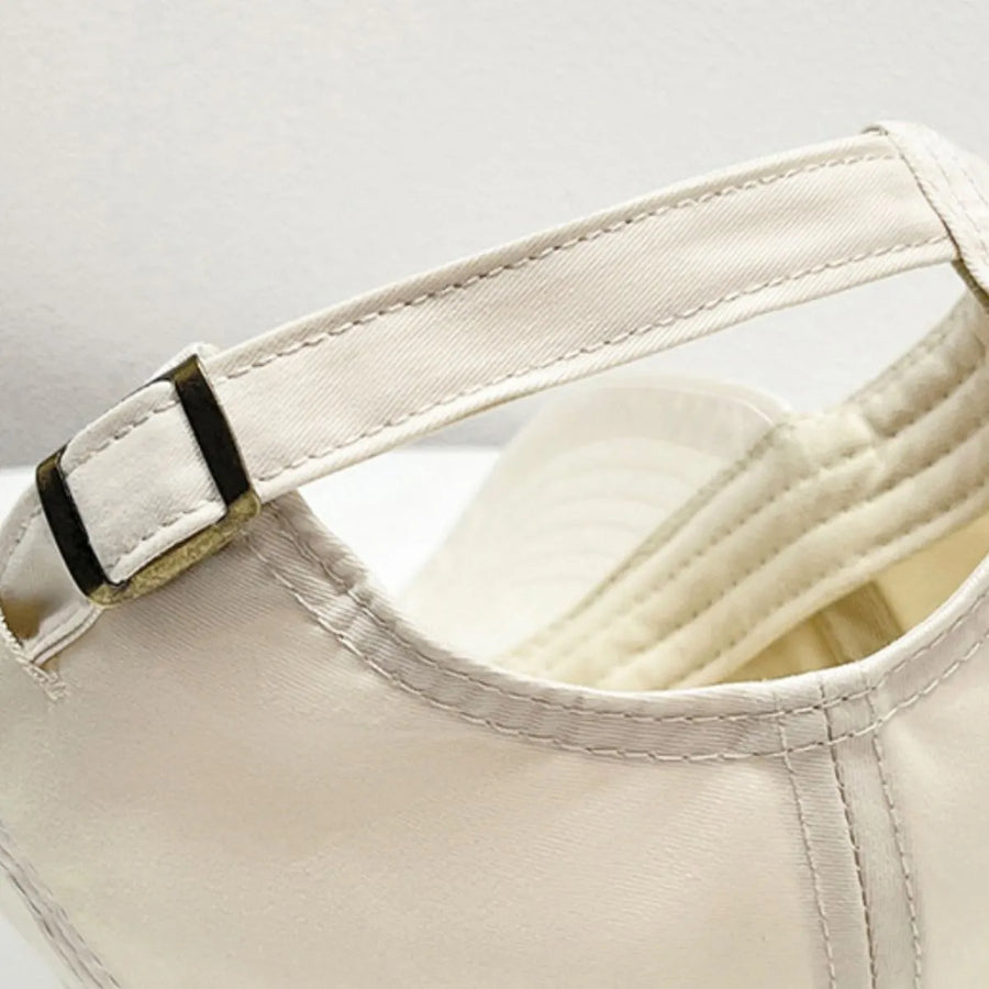 Cream baseball cap with adjustable strap detail