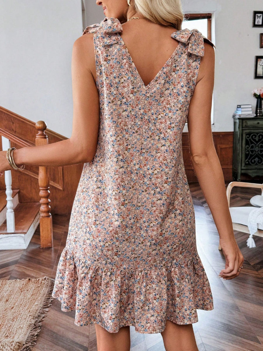 Floral tie strap mini dress in nude pink with ruffled hem and V-neck.