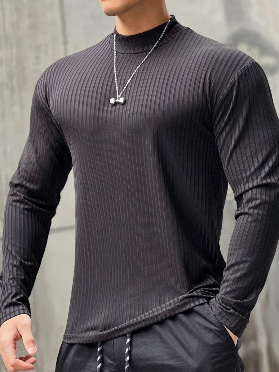 Black ribbed mock neck muscle fit long sleeve shirt with a silver dumbbell pendant necklace.