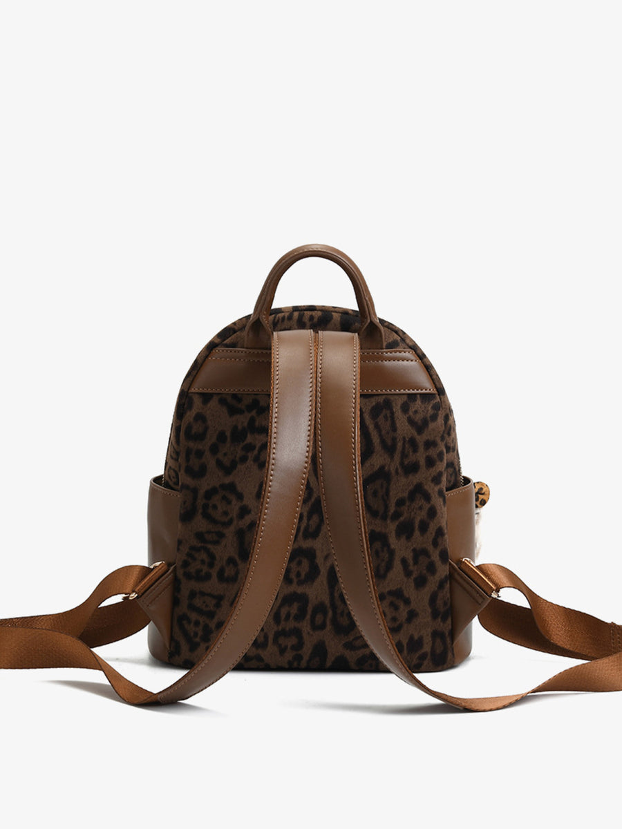 Brown leopard print mini backpack with adjustable straps and leather trim.