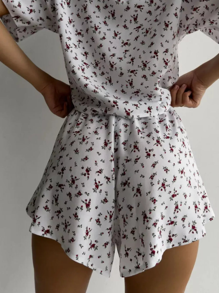 Women's white floral lounge set with relaxed top and flared shorts.